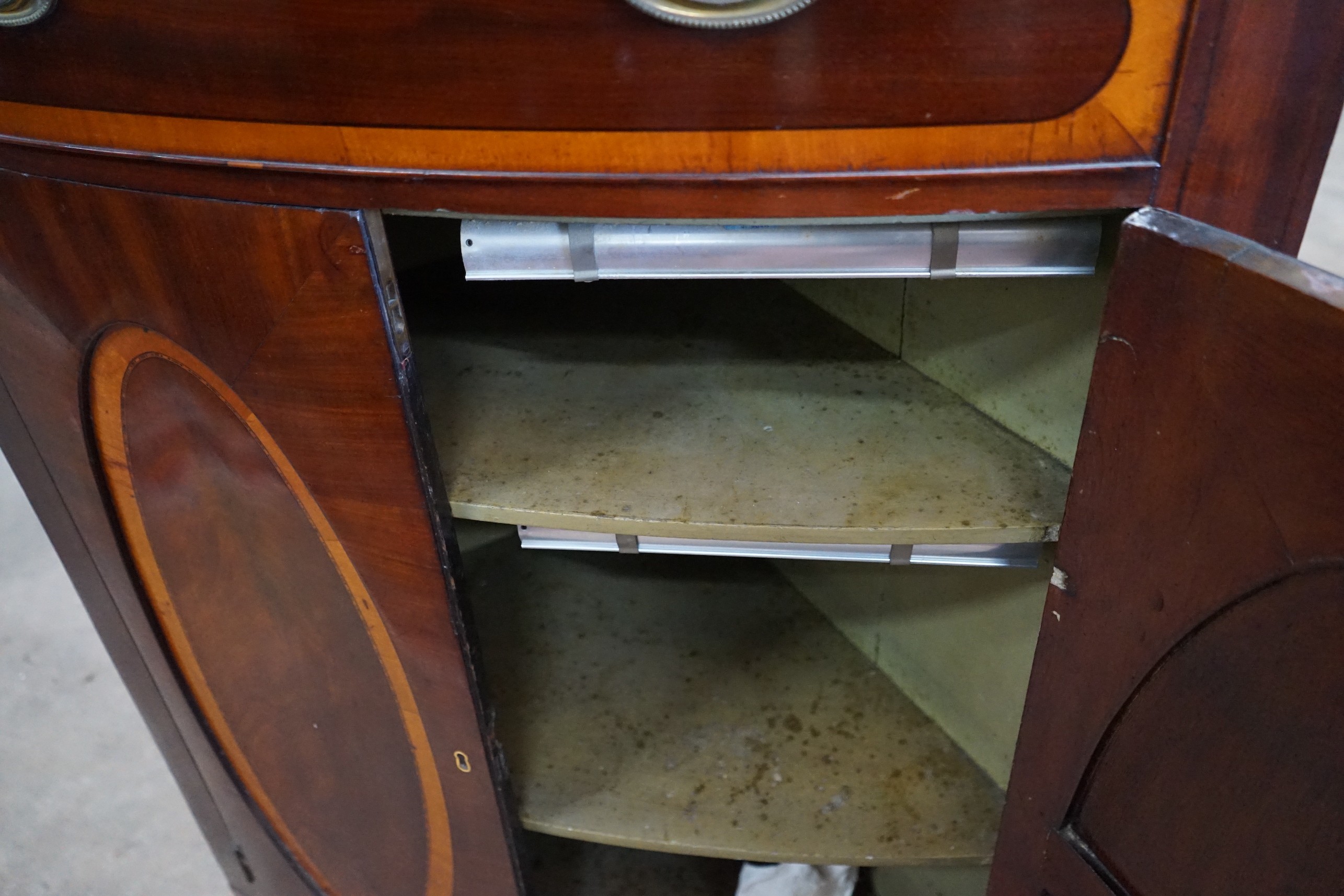 A large Regency mahogany bowfront standing corner cabinet, width 88cm, depth 47cm, height 246cm